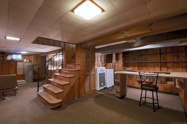 a living room with furniture a air conditioner vent and a window