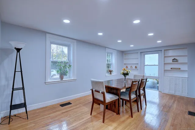 a view of a dining room with furniture and wooden floor