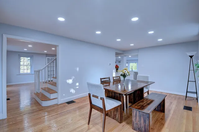 a dining room with furniture and wooden floor