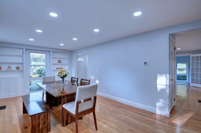 a view of a dining room with furniture and window