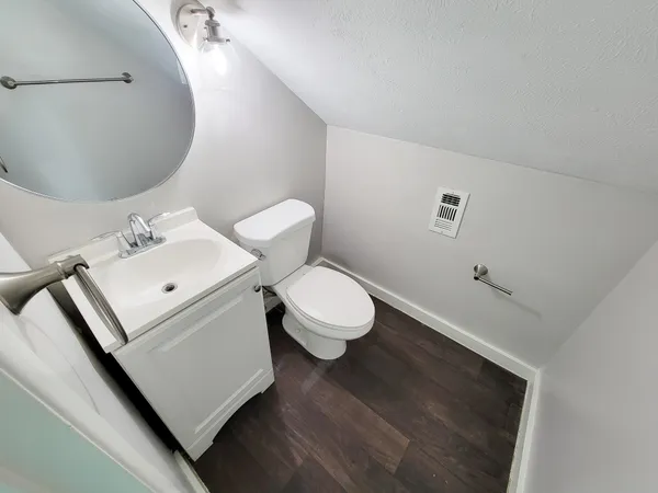 a white toilet sitting next to a bathroom sink