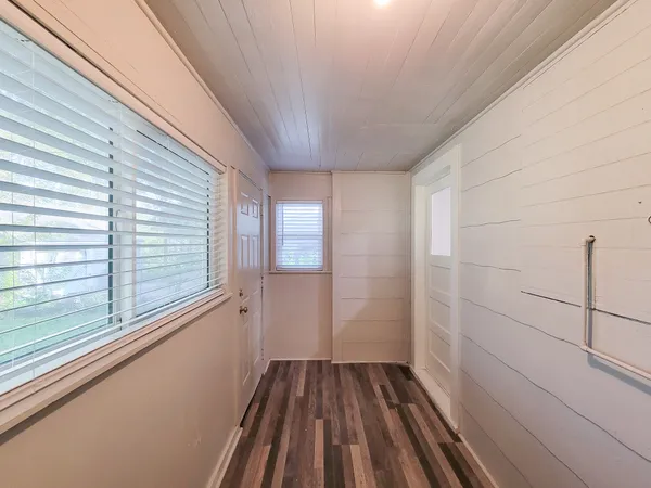 a view of a room with wooden floor and white walls