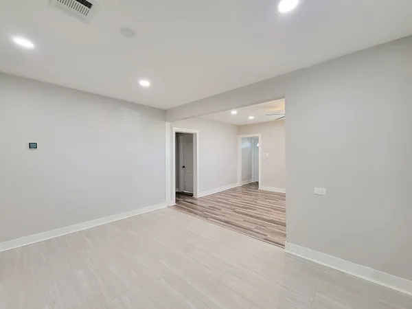 a view of an empty room and wooden floor