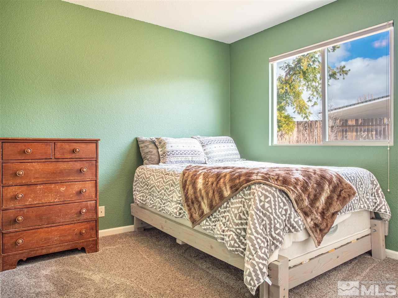 10040 Stonefield Drive Reno, NV 89521 - Photo 13 of 24 a bedroom with a bed and window