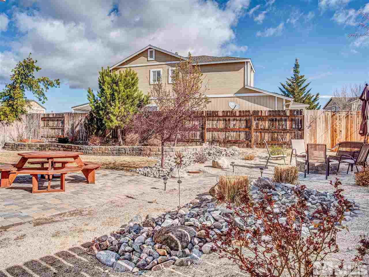 10040 Stonefield Drive Reno, NV 89521 - Photo 19 of 24 a view of a chairs and table in a backyard