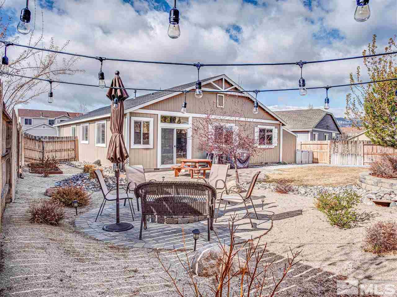 10040 Stonefield Drive Reno, NV 89521 - Photo 21 of 24 a view of a patio with a table and chairs under an umbrella