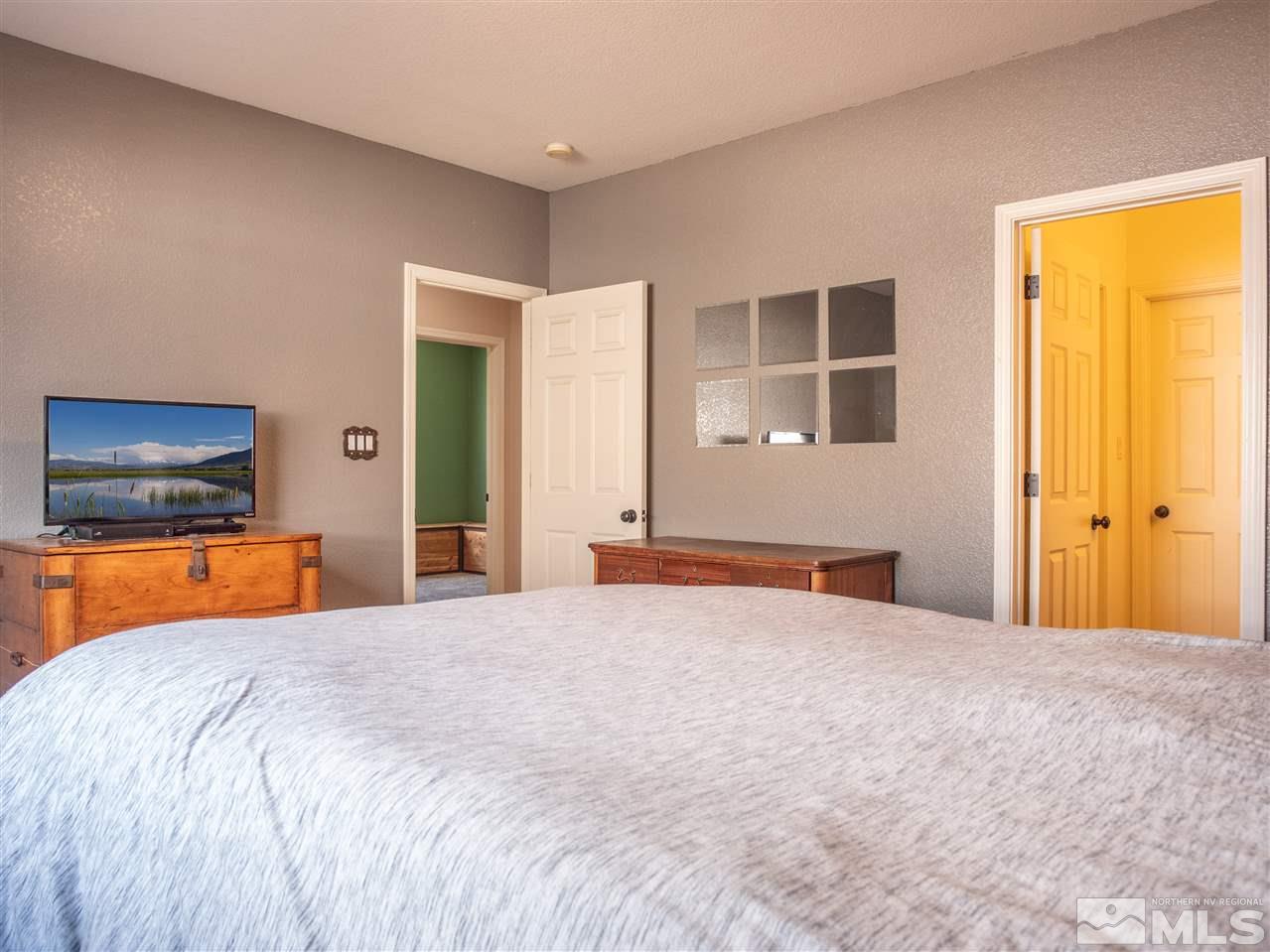 10040 Stonefield Drive Reno, NV 89521 - Photo 23 of 24 a bedroom with a bed and a television in it