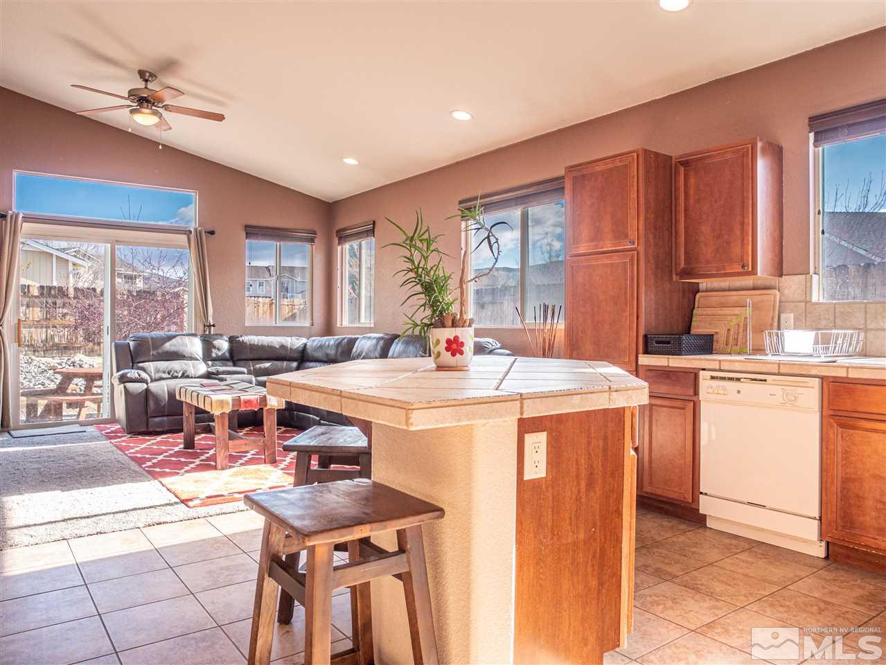 10040 Stonefield Drive Reno, NV 89521 - Photo 8 of 24 a kitchen with a stove a sink and a refrigerator