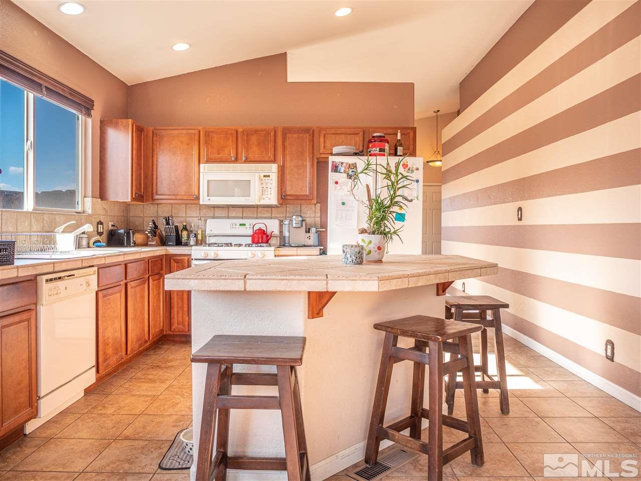 10040 Stonefield Drive Reno, NV 89521 - Photo 9 of 24 a kitchen with a sink cabinets and window