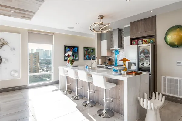 a large kitchen with a table and chairs