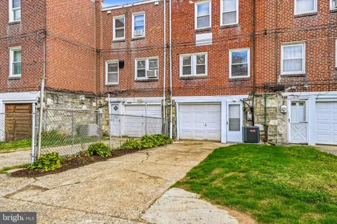 a view of a brick building next to a yard