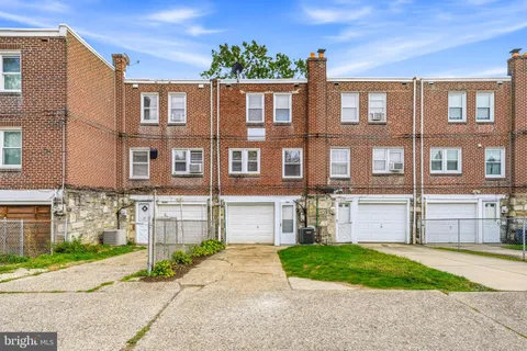 a front view of a house with a garden and entryway