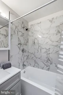 a bathroom with a bathtub and shower