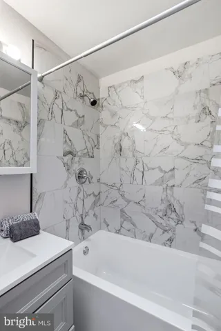 a bathroom with a bathtub and shower