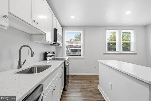 a kitchen that has a sink and a stove in it