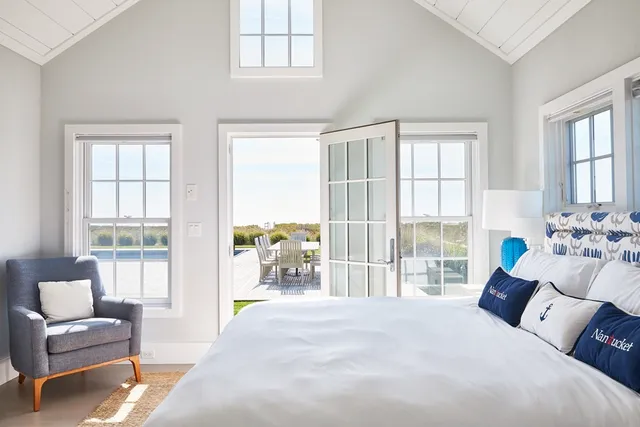 a bedroom with a bed and glass window