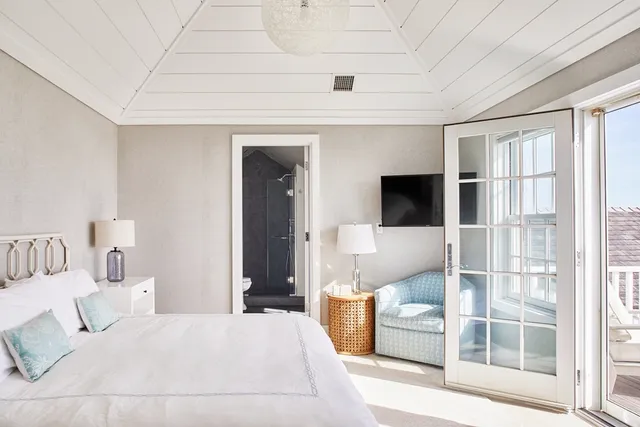 a bedroom with furniture and a flat screen tv