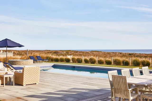 a front view of a house with a garden and plants
