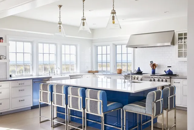 a large kitchen with a table and chairs