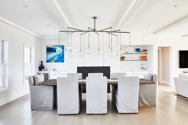 a kitchen that has a lot of cabinets in it and wooden floors