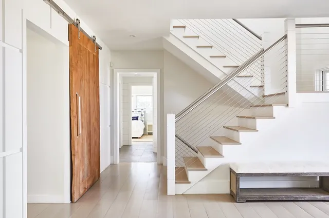 a view of entryway and hall with wooden floor
