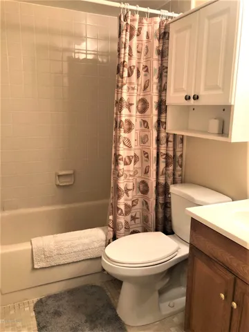 a bathroom with a toilet a sink and a shower