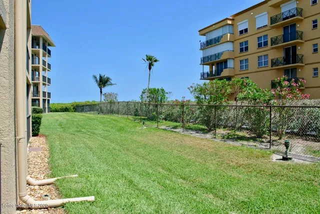 a view of a garden with a building