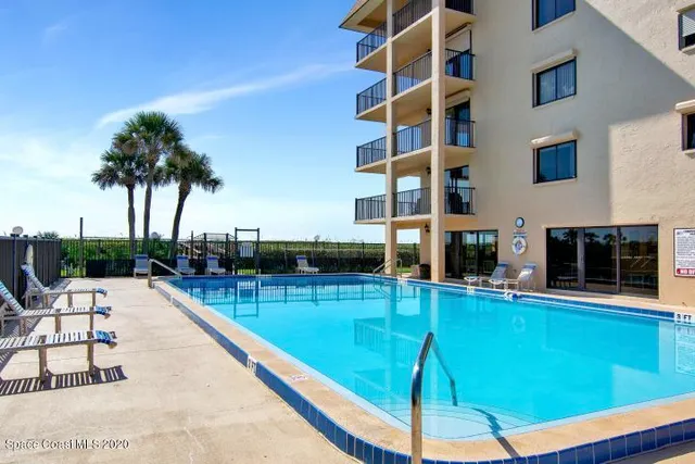 a swimming pool with outdoor seating and yard