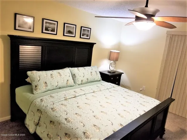 a bedroom with a bed and a night stand