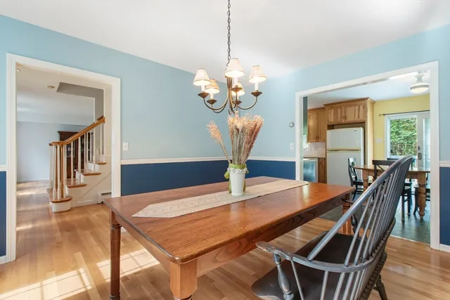 a view of a dining room with furniture wooden floor and chandelier