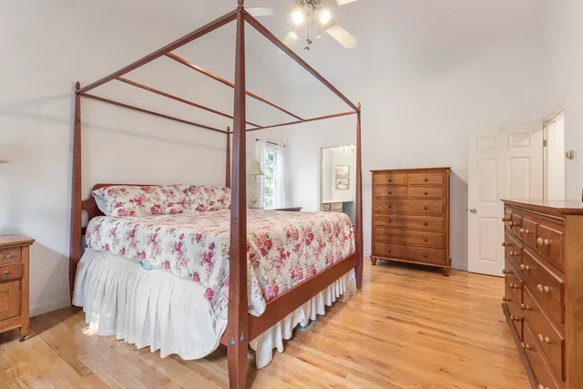 a bedroom with a large bed and a dresser