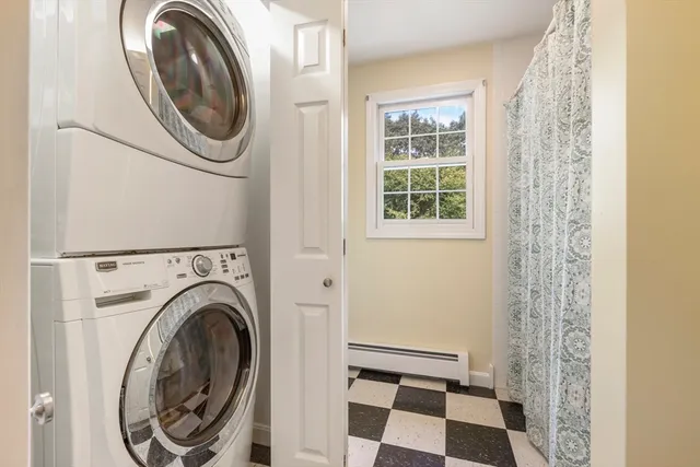 a view of a bedroom with washer and dryer