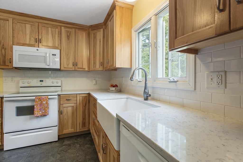 11 Old Farm Road Douglas, MA 01516 - Photo 4 of 42 a kitchen with granite countertop a sink a stove and cabinets
