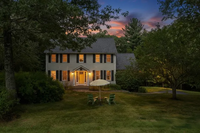 a view of a house with a yard and sitting area