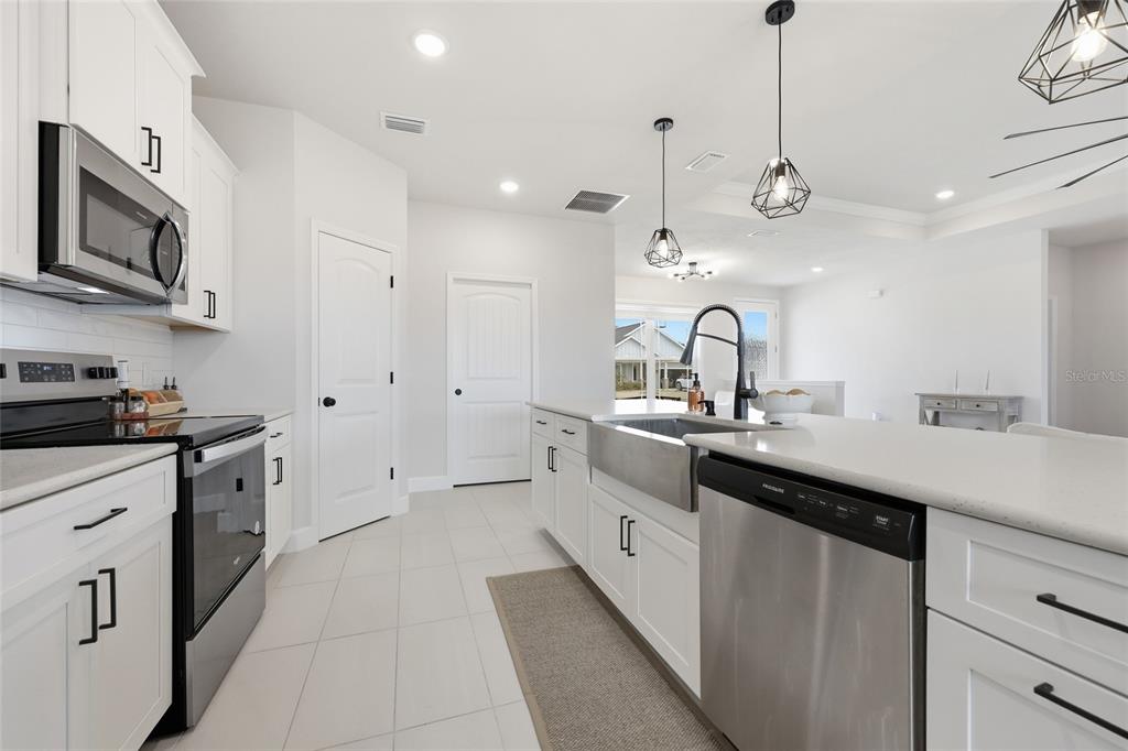 1922 Southwest 244th Way Newberry, FL 32669 - Photo 11 of 31 a large kitchen with stainless steel appliances lots of counter space sink and a refrigerator