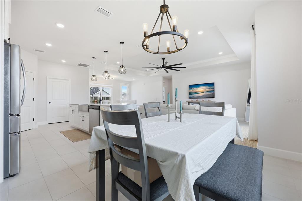 1922 Southwest 244th Way Newberry, FL 32669 - Photo 15 of 31 a kitchen with stainless steel appliances kitchen island granite countertop a table chairs and a refrigerator