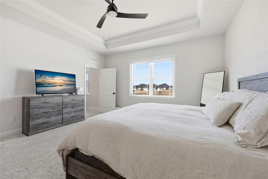 1922 Southwest 244th Way Newberry, FL 32669 - Photo 17 of 31 a bedroom with a bed and a flat screen tv