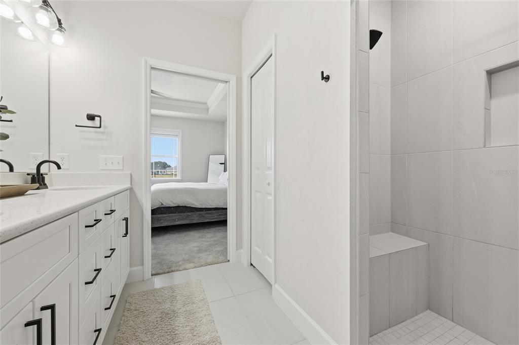 1922 Southwest 244th Way Newberry, FL 32669 - Photo 18 of 31 a en suite bathroom with a double vanity sink and a mirror