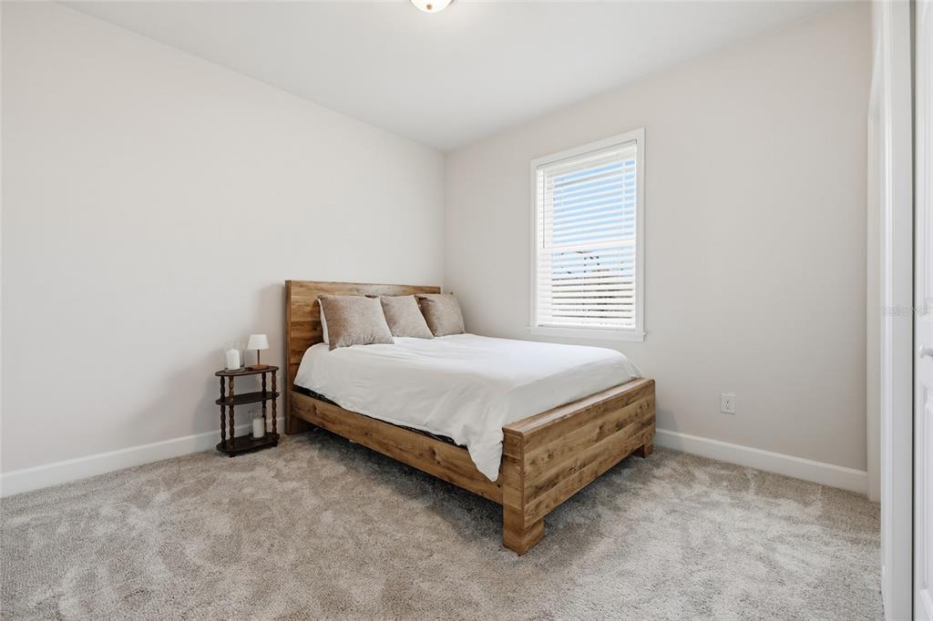1922 Southwest 244th Way Newberry, FL 32669 - Photo 20 of 31 a bed sitting in a bedroom next to a window