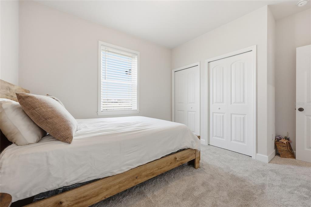 1922 Southwest 244th Way Newberry, FL 32669 - Photo 21 of 31 a bedroom with a bed and a cabinets