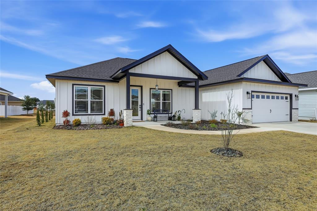 1922 Southwest 244th Way Newberry, FL 32669 - Photo 3 of 31 a front view of a house with garden