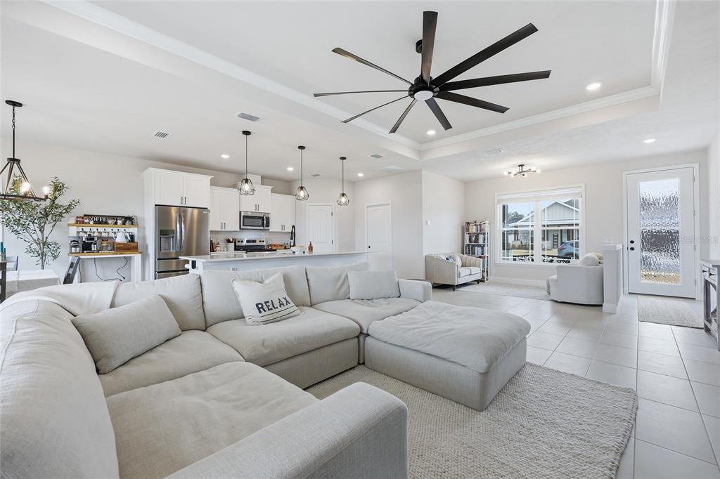 1922 Southwest 244th Way Newberry, FL 32669 - Photo 6 of 31 a living room with furniture kitchen view and a chandelier