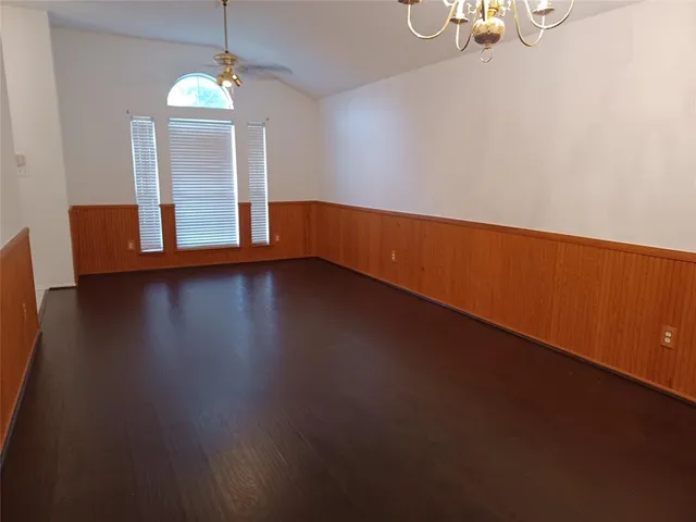 a view of wooden floor and windows in a room