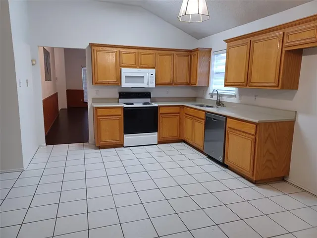 a kitchen with stainless steel appliances granite countertop a refrigerator sink and cabinets