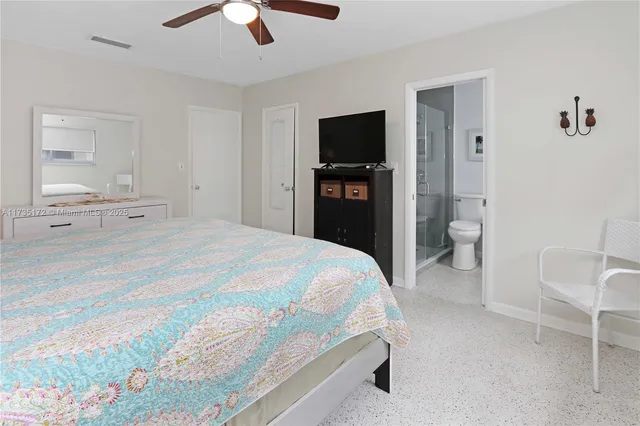 a bedroom with a bed and a television