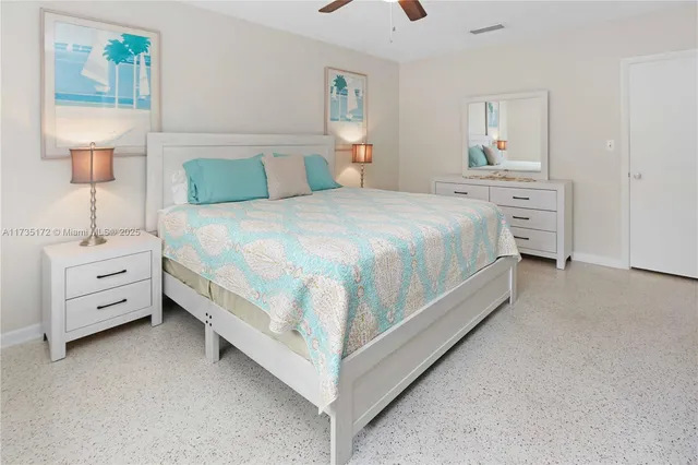 a bedroom with a bed and a night stand