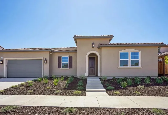 a front view of a house with garden