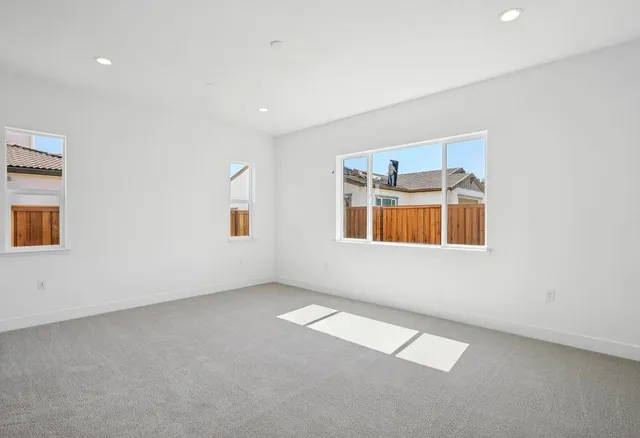a bedroom with a bed and painting on the wall