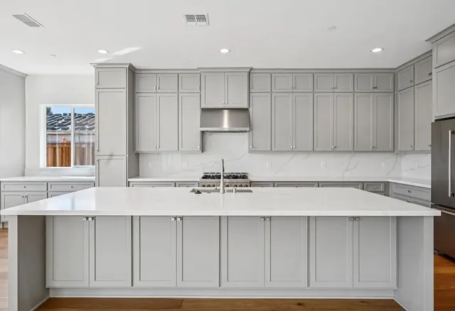 a kitchen with a sink cabinets and window