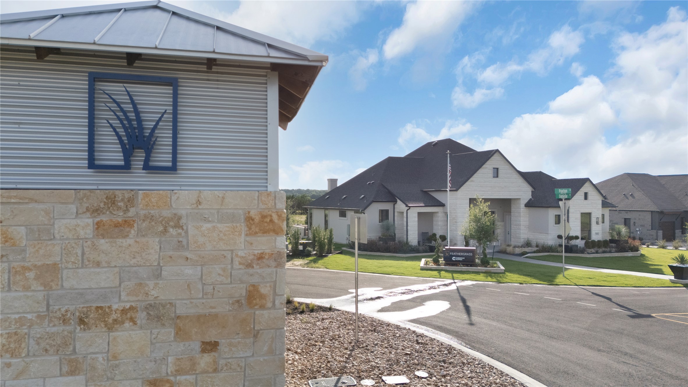 208 Kamas Way Georgetown, TX 78633 - Photo 2 of 33 The striking stone and corrugated metal exterior of the community entrance welcomes residents and guests.